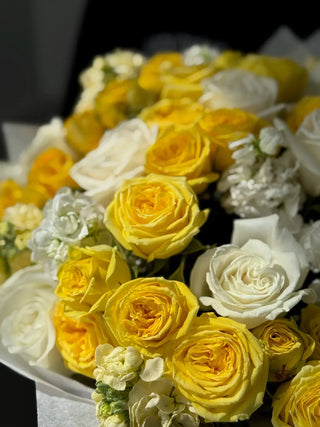 Bouquet of white garden roses and yellow spray roses