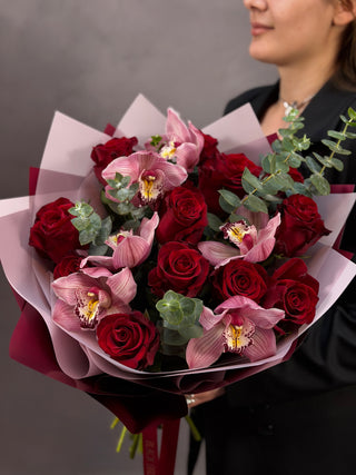 Bouquet of red roses and pink orchids
