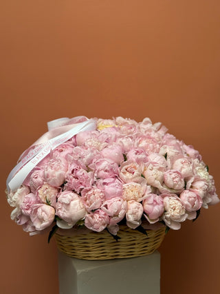 100 pink peonies in a basket