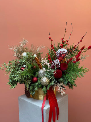 Christmas arrangement in gold vase with red and gold ornament
