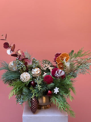 Red and gold Christmas arrangement in gold compote vase