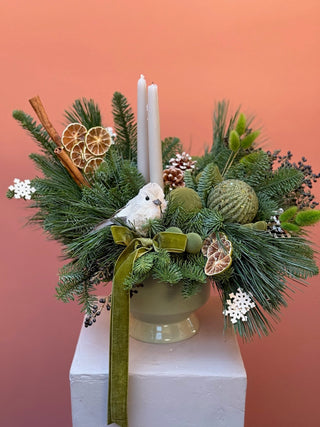 Christmas arrangement in natural colors with bird and green ornament