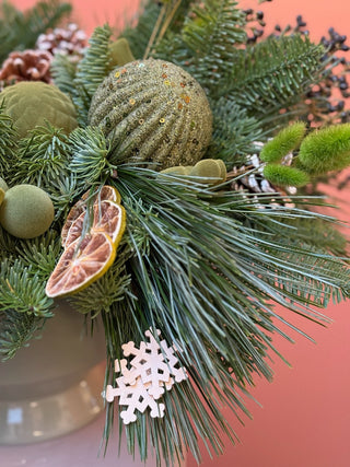 Christmas arrangement in natural colors with bird and green ornament
