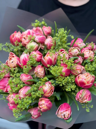 Bouquet of pink double tulips and alchemilla