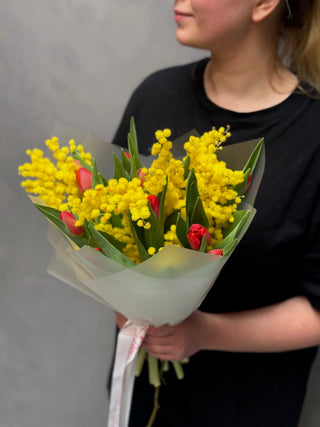 Bouquet of red tulips and mimosa